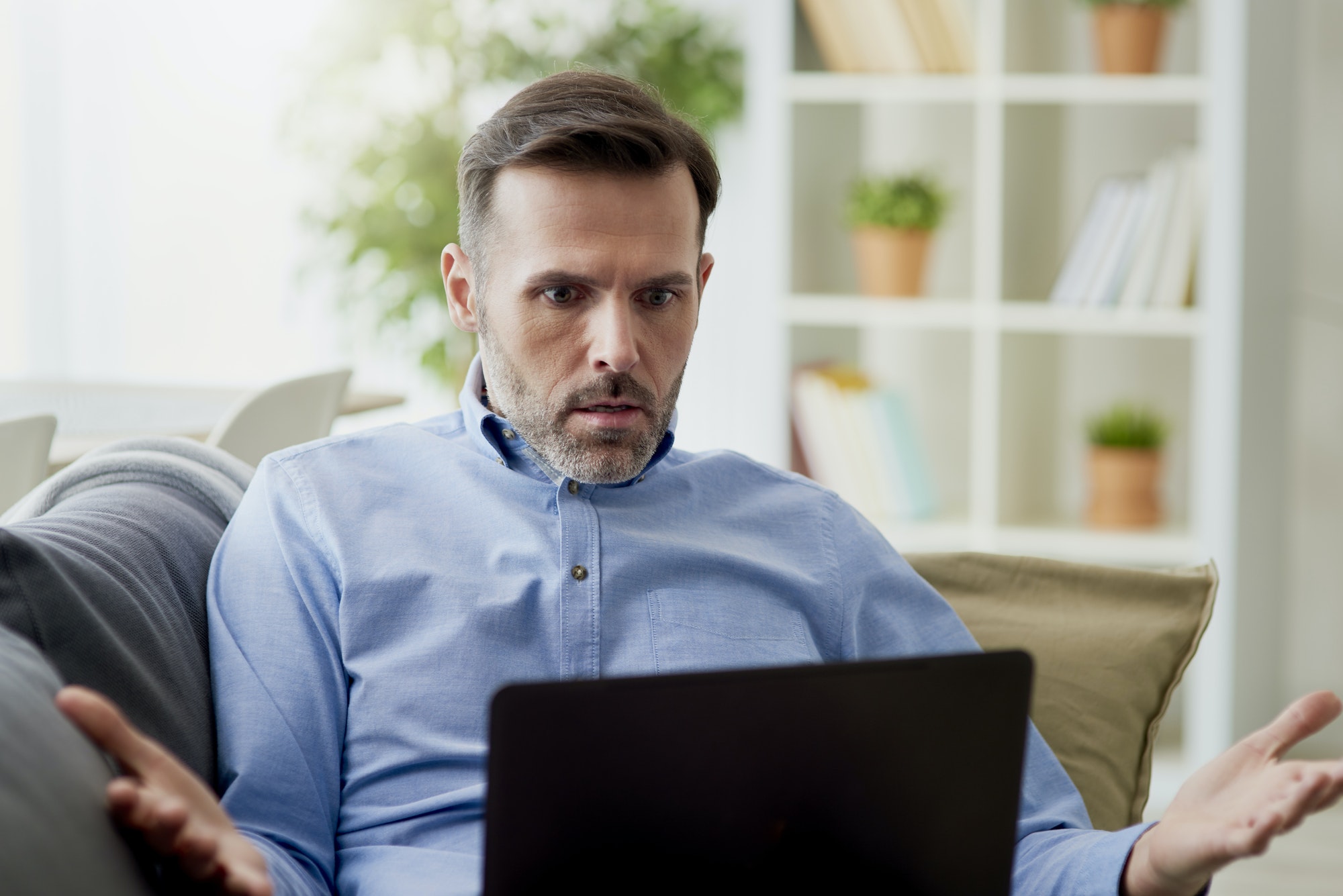 Angry man working home on a computer